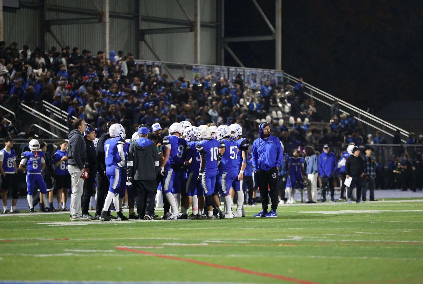 McNary HS Football Team in Huddle with Coaches